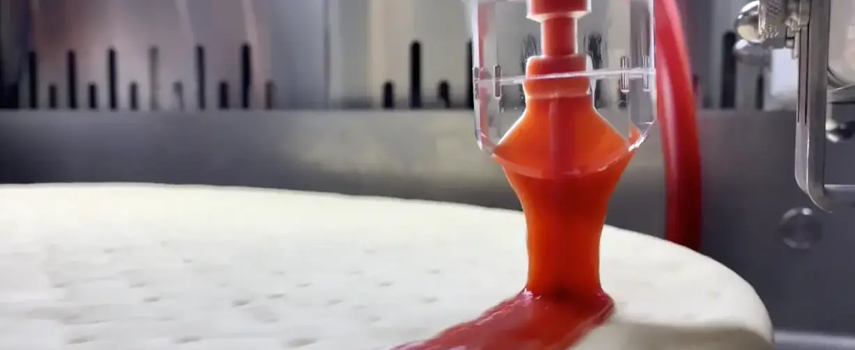 PizzaBot laying down sauce